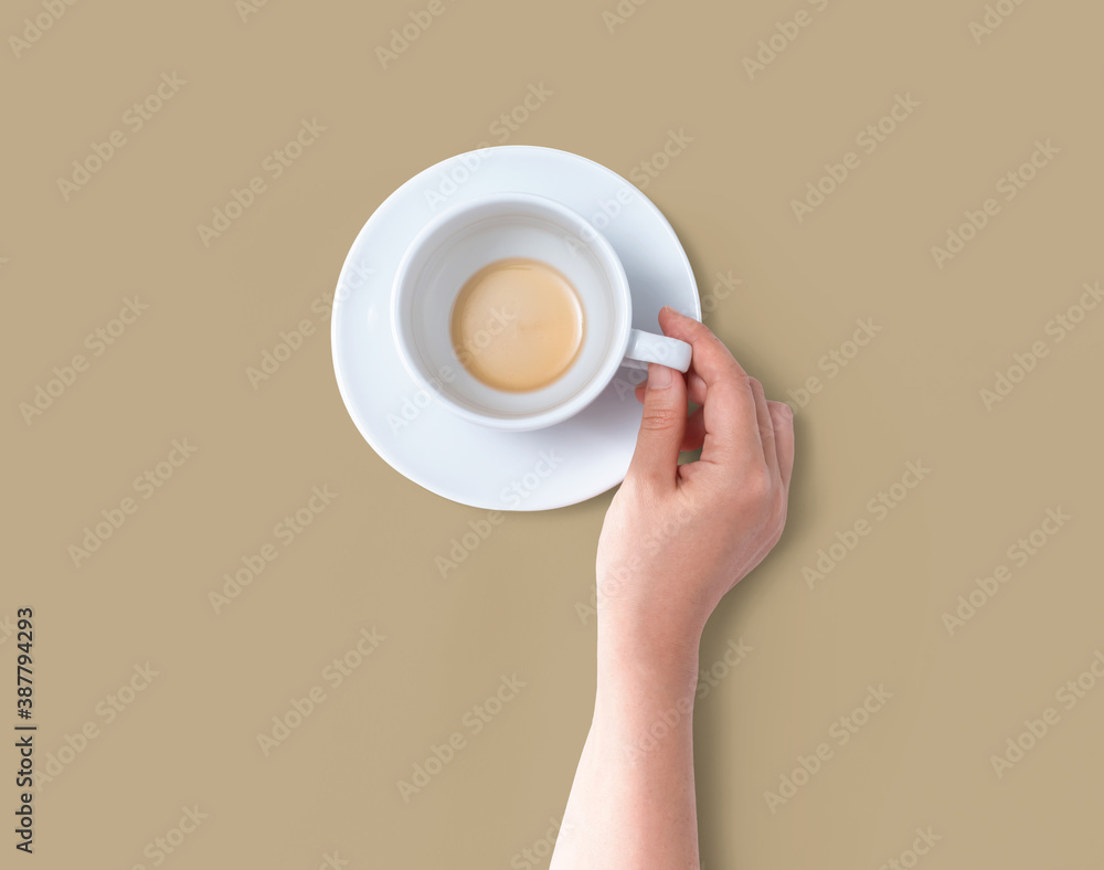 Female hand holding a tea cup overhead view - flat lay