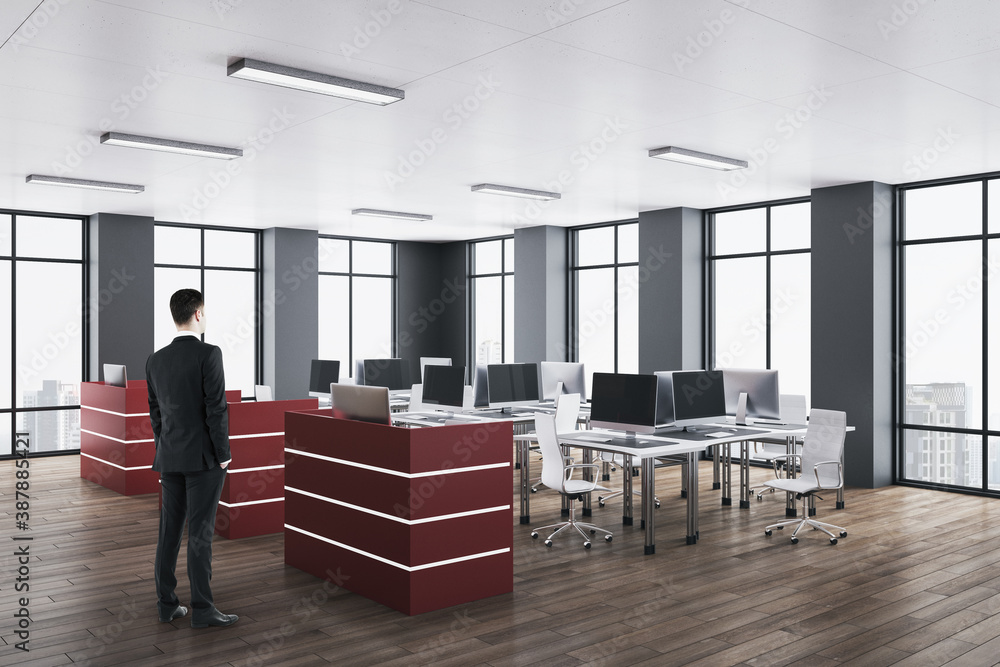 Businessman standing in luxury office interior with panoramic city view