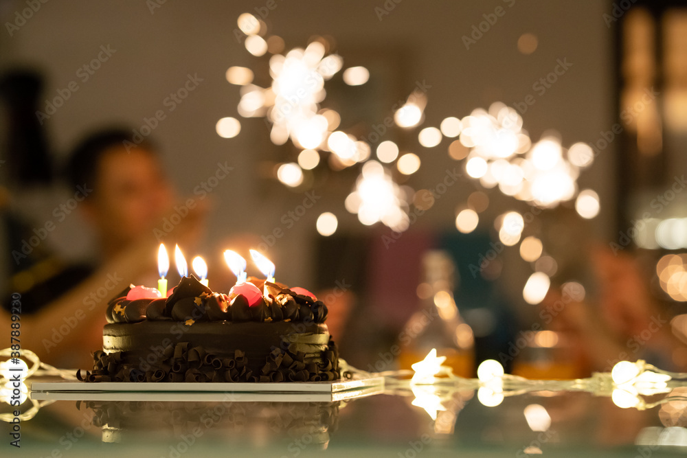 Asian big family enjoying birthday party, They are playing sparkler.