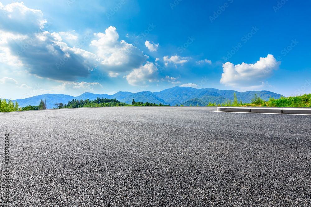 Asphalt road and green mountain natural scenery in Hangzhou on a sunny day.