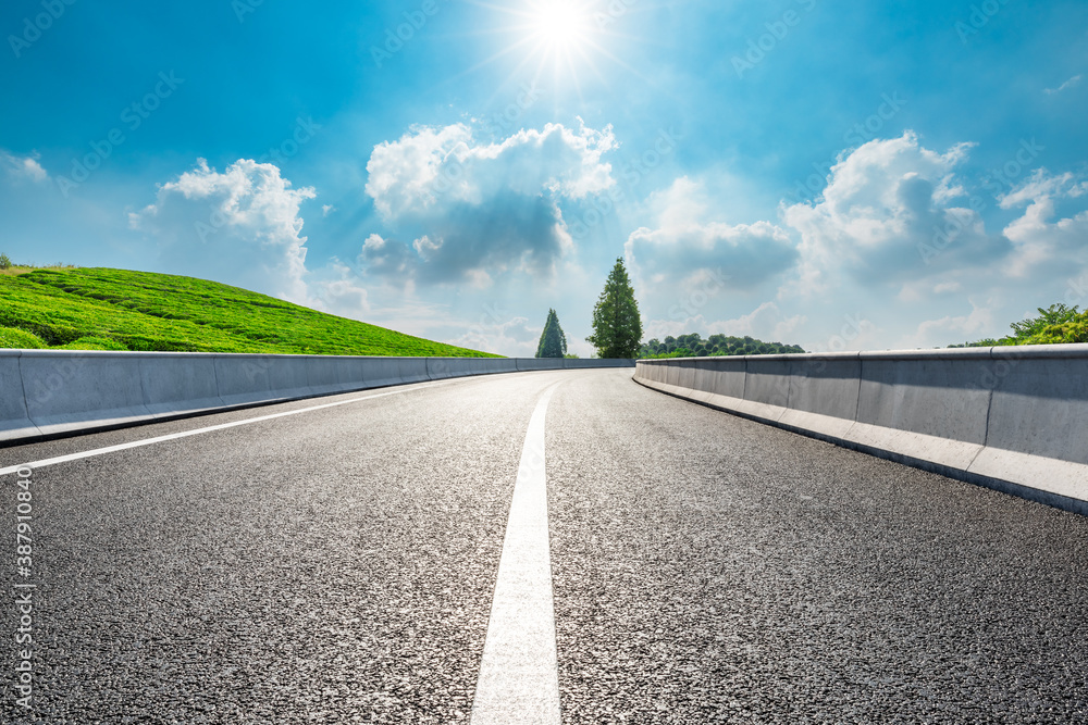 Countryside asphalt road and green tea plantations with mountain natural scenery in Hangzhou on a su