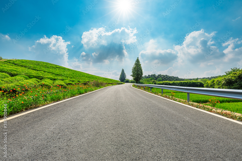 Countryside asphalt road and green tea plantations with mountain natural scenery in Hangzhou on a su