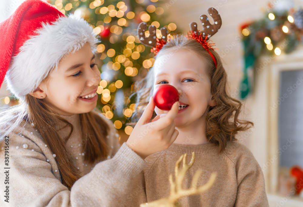 Kids are having fun near Christmas tree