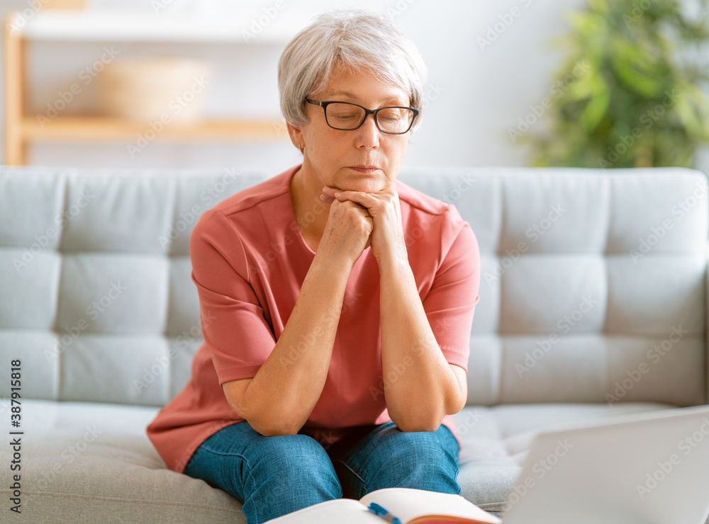 senior woman is using laptop