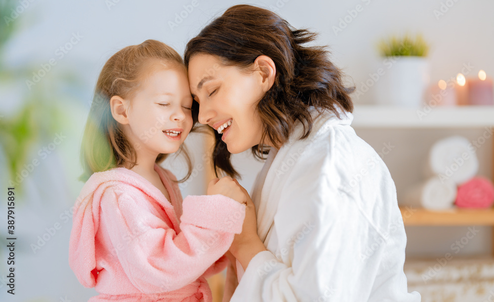 Mother and daughter caring for skin