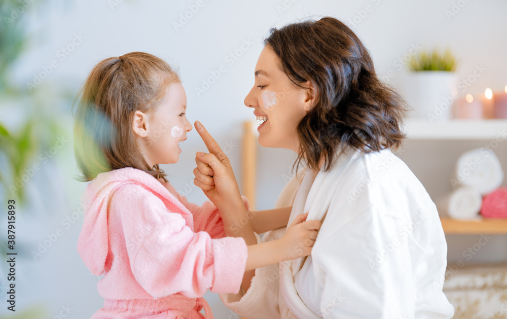 Mother and daughter caring for skin