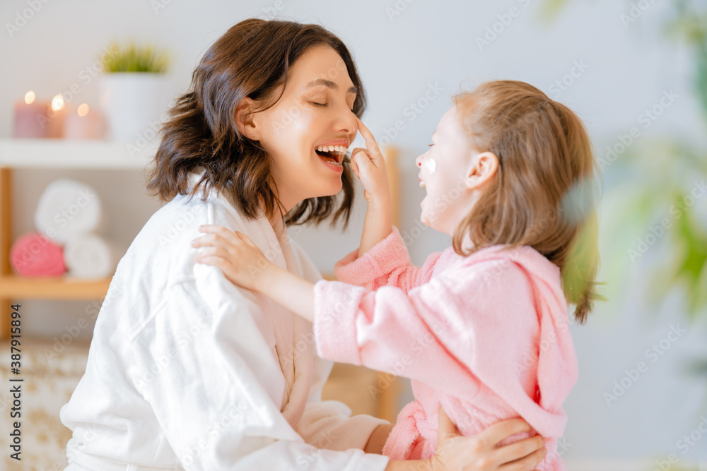 Mother and daughter caring for skin