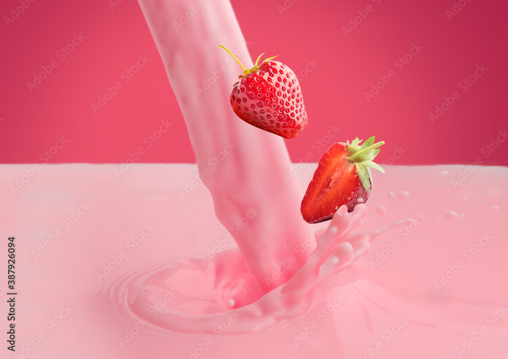 Pouring strawberry milk and berries on color background