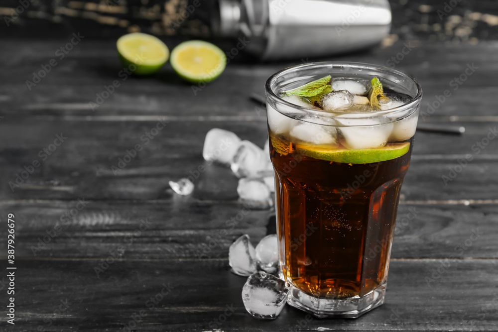 Glass of tasty Cuba Libre cocktail on table