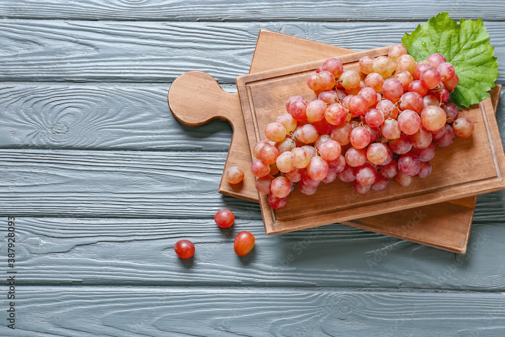 Sweet ripe grapes on wooden table