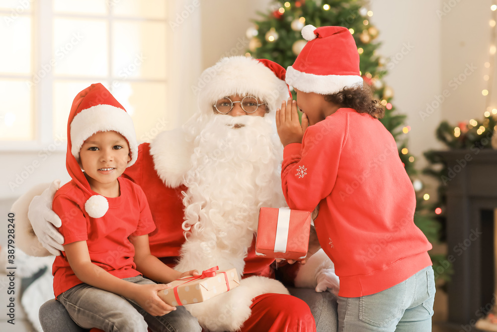 African-American children telling Santa their wish at home on Christmas eve