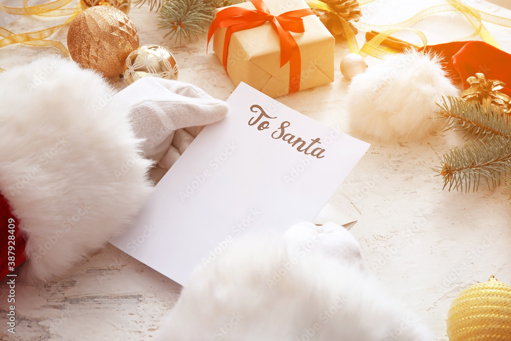 Santa with letter and Christmas decor on white background