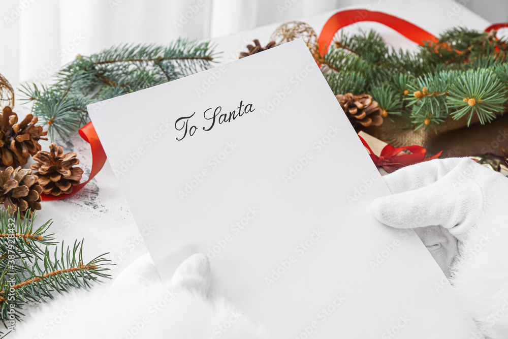 Santa with letter and Christmas decor on white background