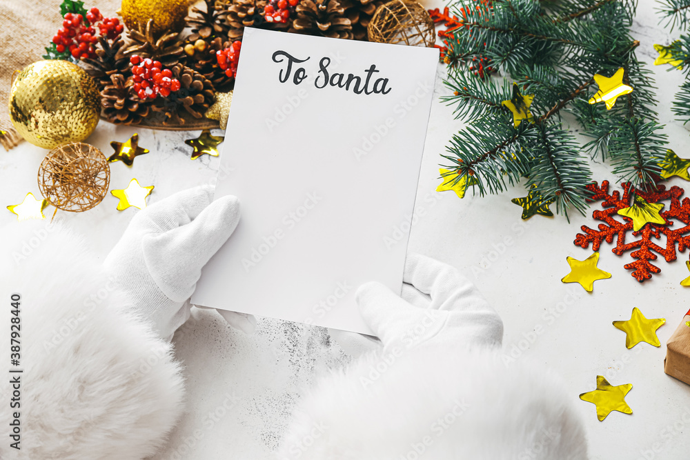 Santa with letter and Christmas decor on white background