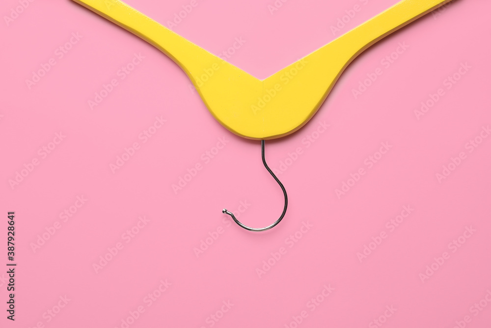 Clothes hanger on color background