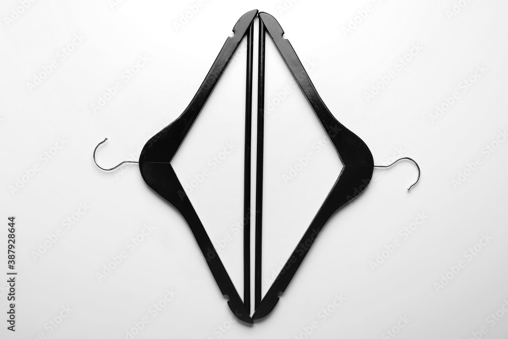 Clothes hangers on light background