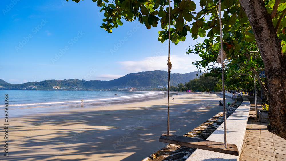 Patong beach in the morning with shadow coconut palm trees on sand beach at Phuket Thailand.