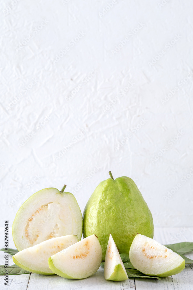 Delicious guava fruit set on white wooden table background with copy space.