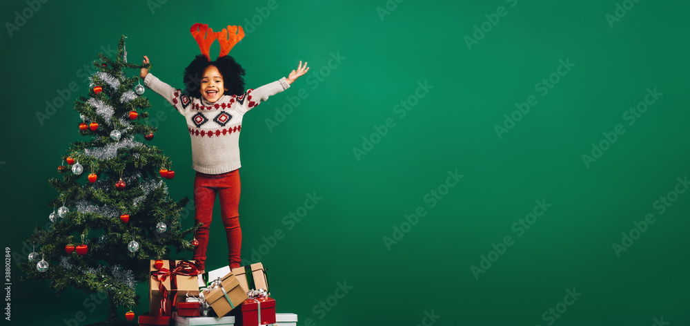 Excited kid standing on gift boxes