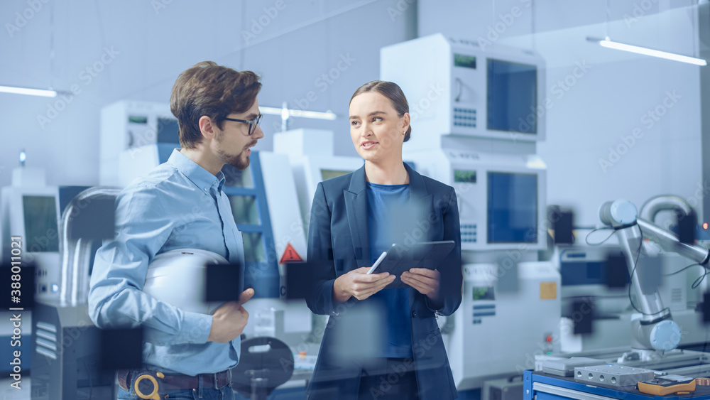 Modern Factory: Female Project Manager and Male Engineer Standing, Talking, Using Digital Tablet for