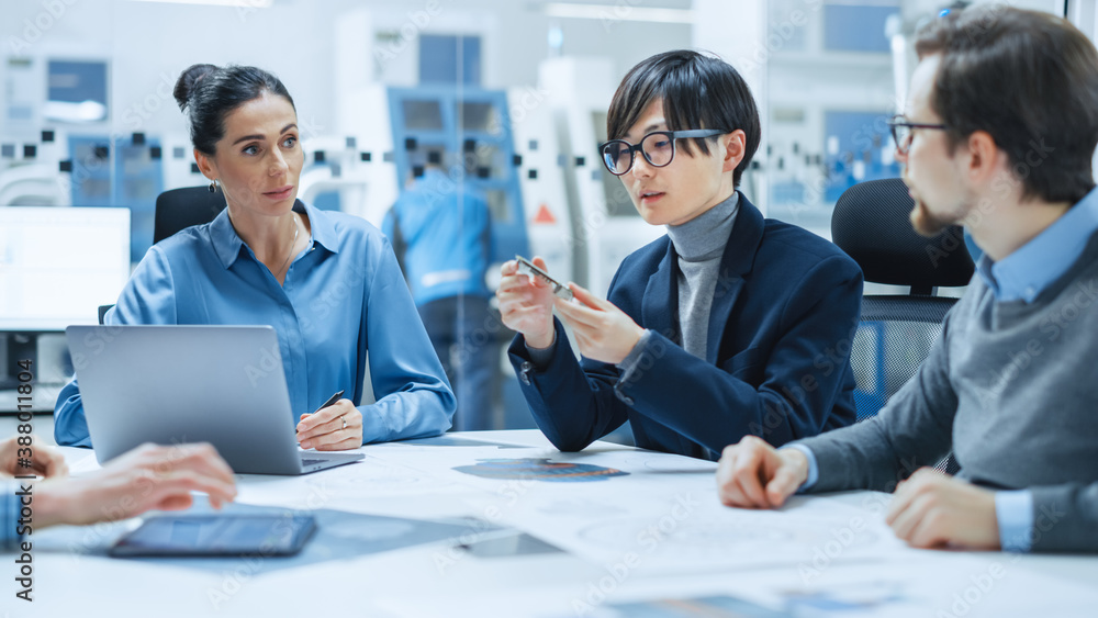 Factory Office Meeting Room: Computer Design Specialist Holds Printed Circuit Board Prototype and Re