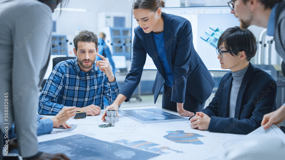 Busy Diverse Team of Engineers and Specialists Gather Around Conference Table, They Discuss Project 