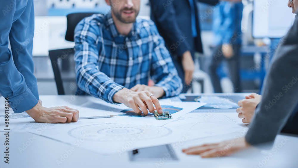 Busy Diverse Team of Computer Engineers and Specialists Gather Around Conference Table and Discuss E