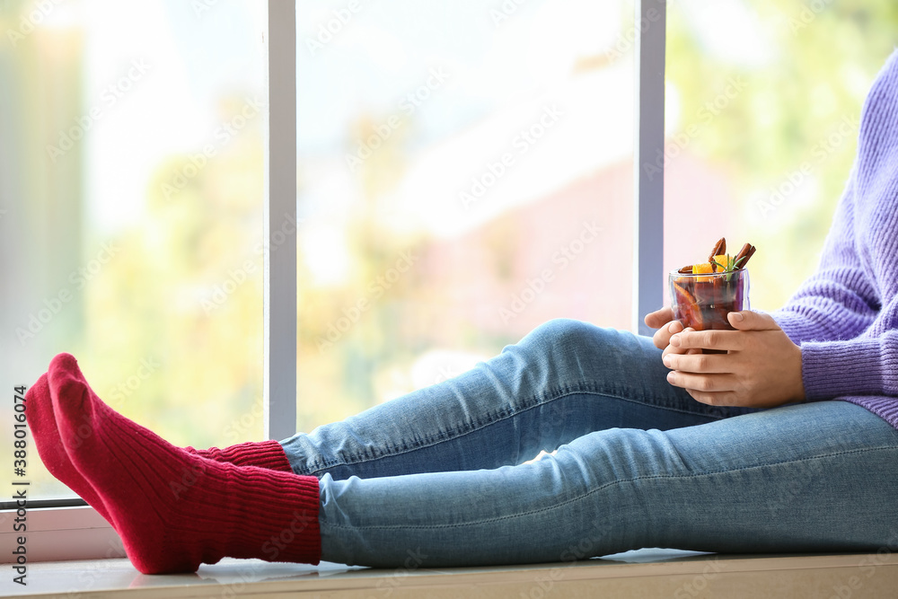 Woman drinking mulled wine at home