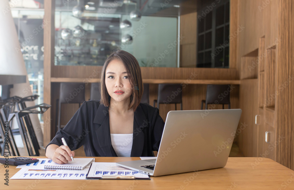 Young Asian women spend their free time using their laptop to educate themselves online and take not