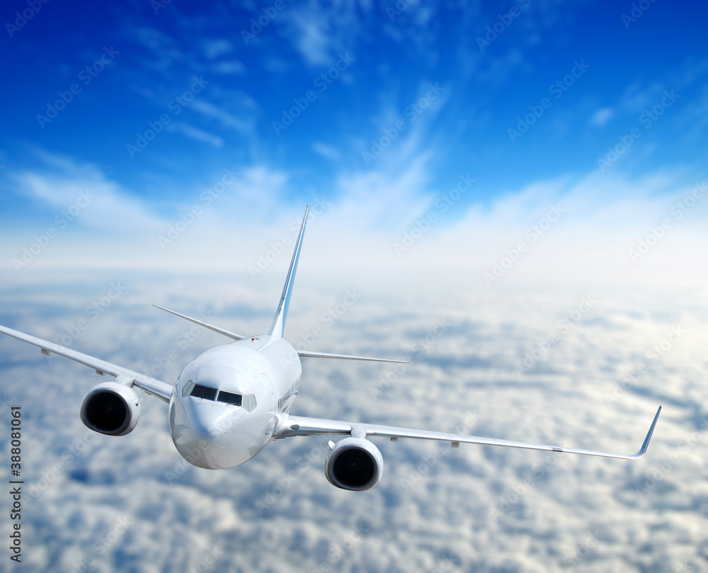 Landscape with airplane is flying in the blue sky and white clouds.