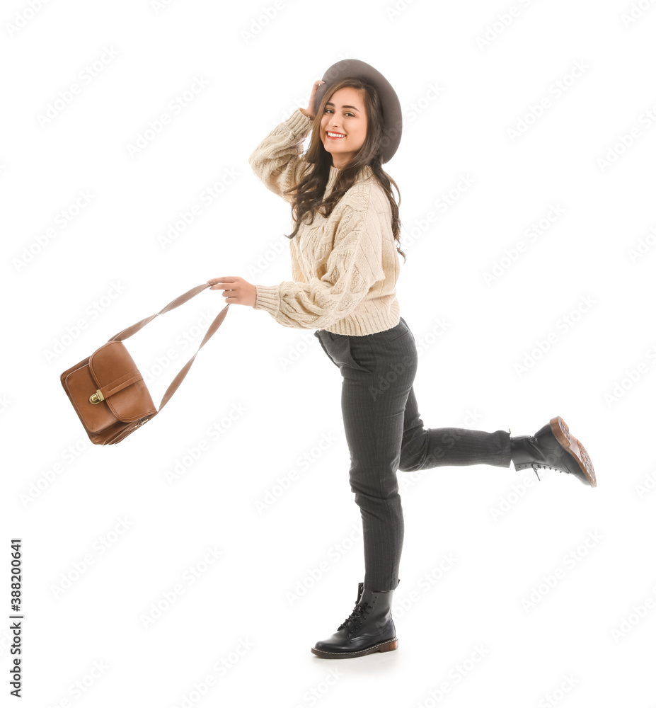 Happy young woman in autumn clothes on white background