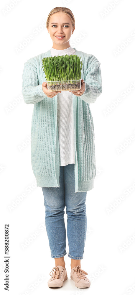 Young woman with wheatgrass on white background