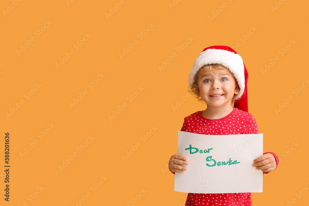 Cute little child with letter to Santa on color background