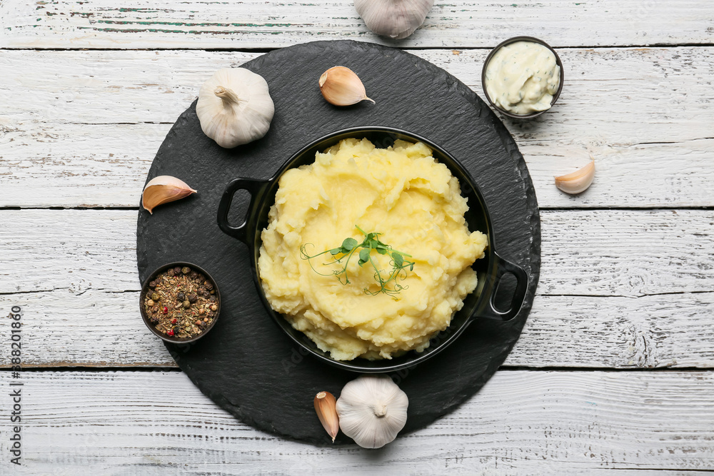 Composition with tasty mashed potato and garlic on table