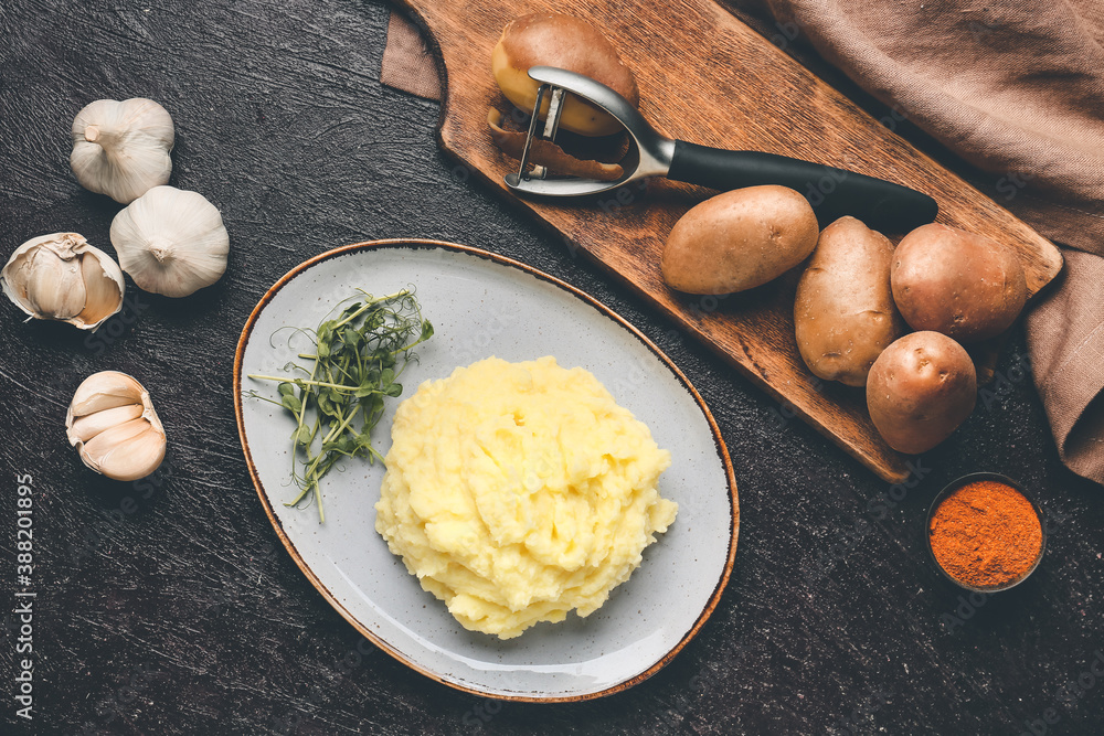 Composition with tasty mashed potato and garlic on table