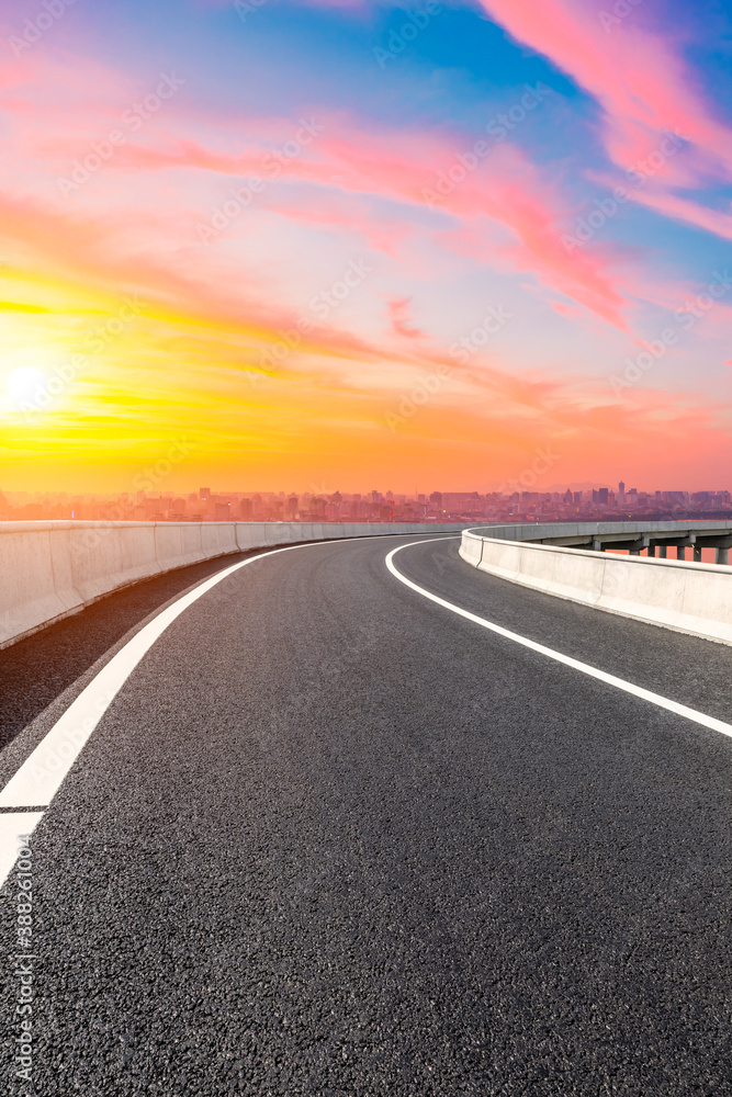 Asphalt viaduct road and city skyline in Hangzhou at sunset.