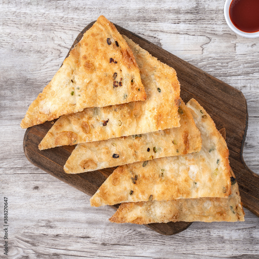 Taiwanese delicious scallion pancake over wooden table background