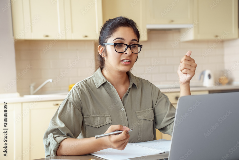 Indian woman online tutor, remote school teacher, distanced office worker talking to webcam during v