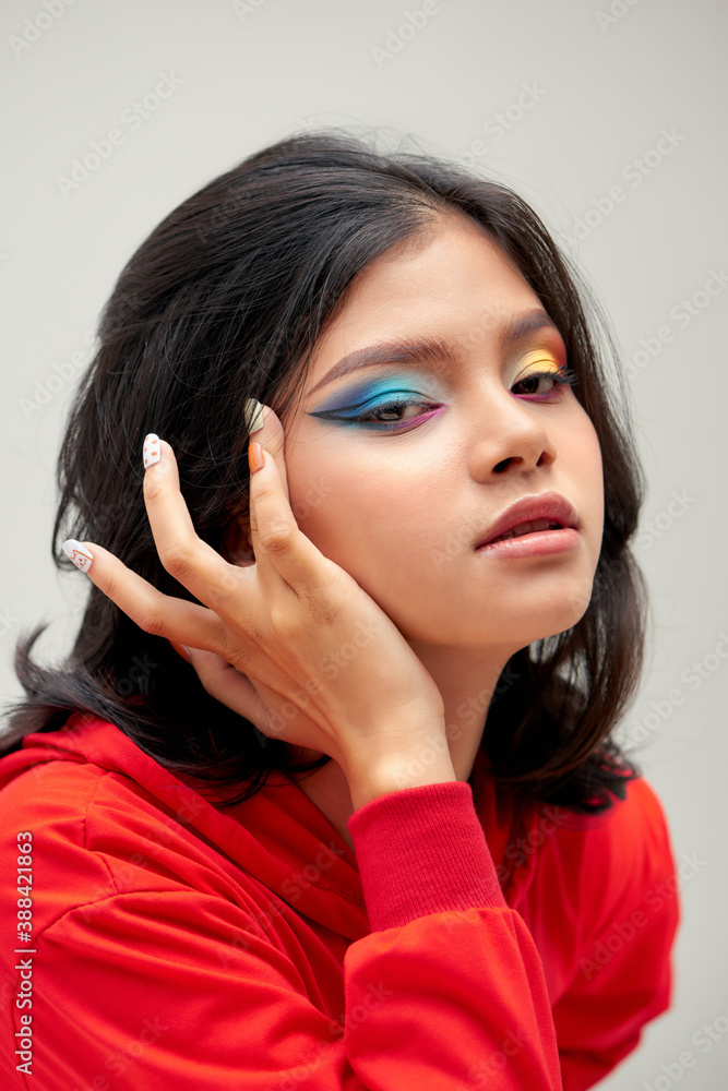 Girl with colorful makeup and manicure