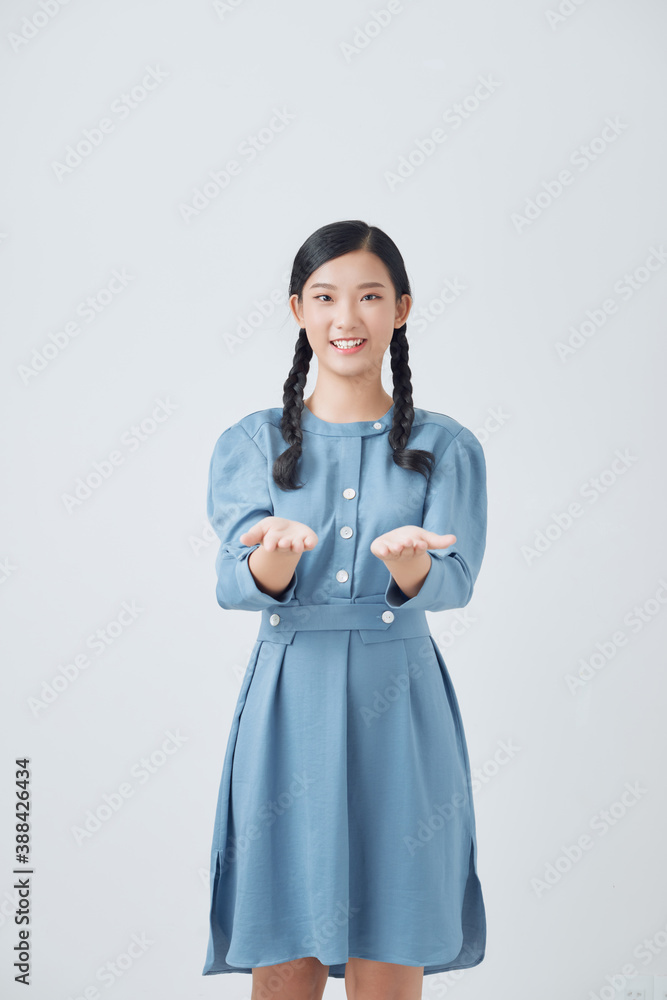 woman showing open hand for product or something portrait on white background