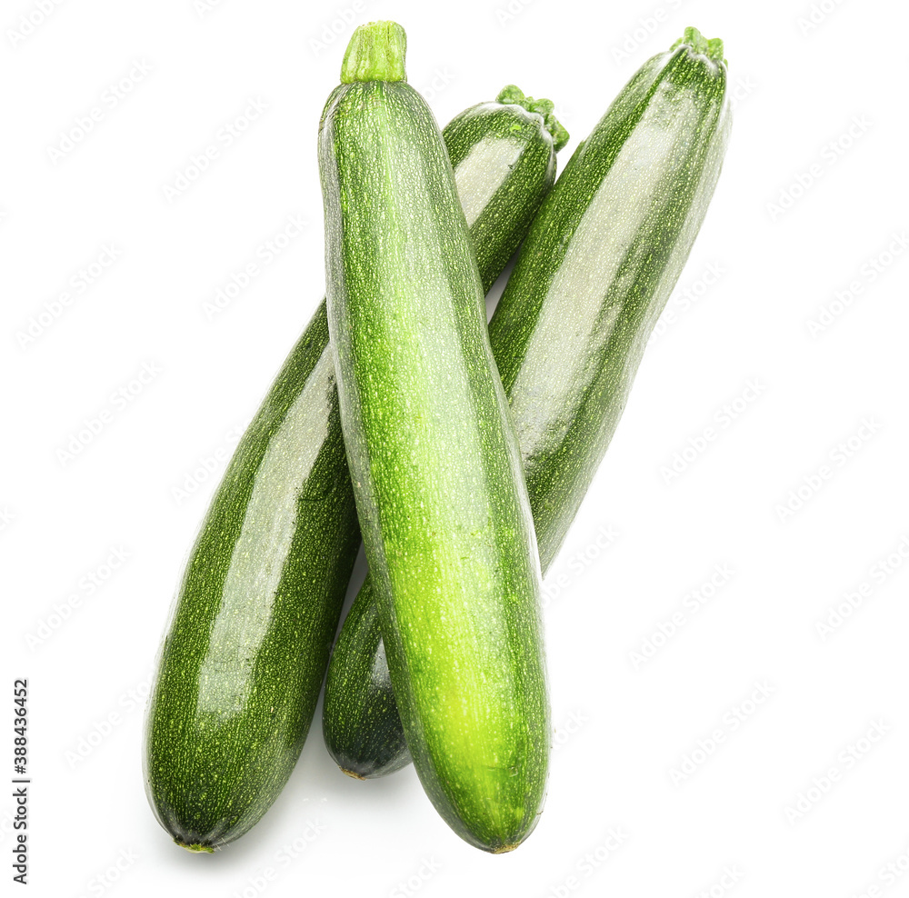 Fresh zucchini squashes on white background