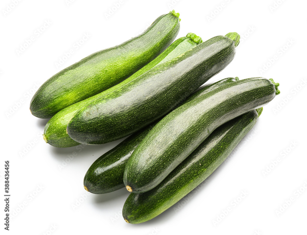 Fresh zucchini squashes on white background