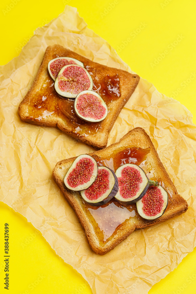 Tasty sandwiches with sweet fig jam on color background