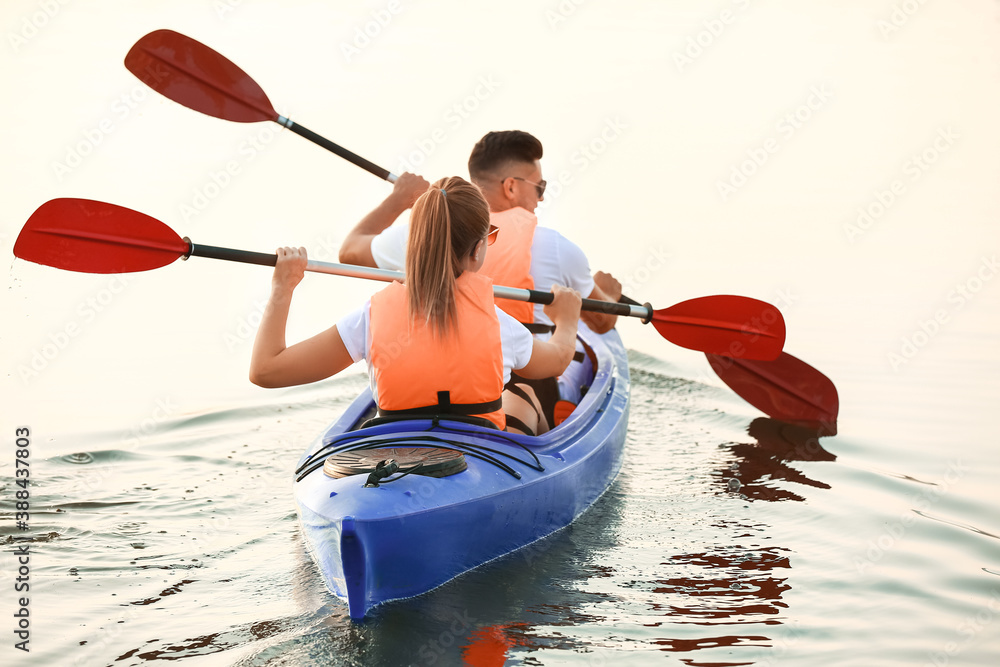 Young couple kayaking in river