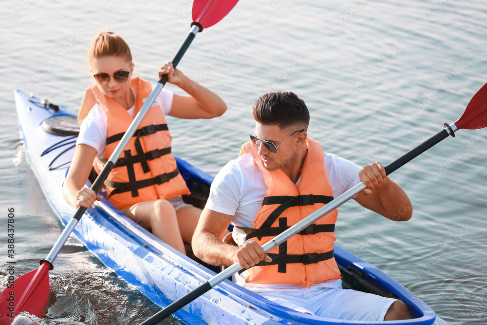 Young couple kayaking in river