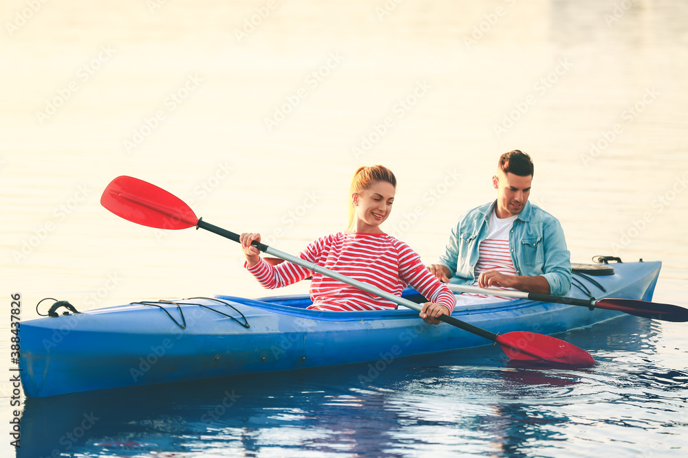 Young couple kayaking in river