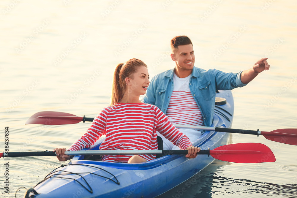 Young couple kayaking in river