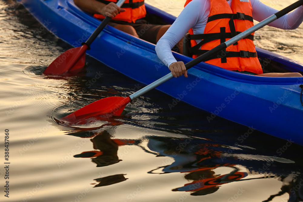 Young couple kayaking in river