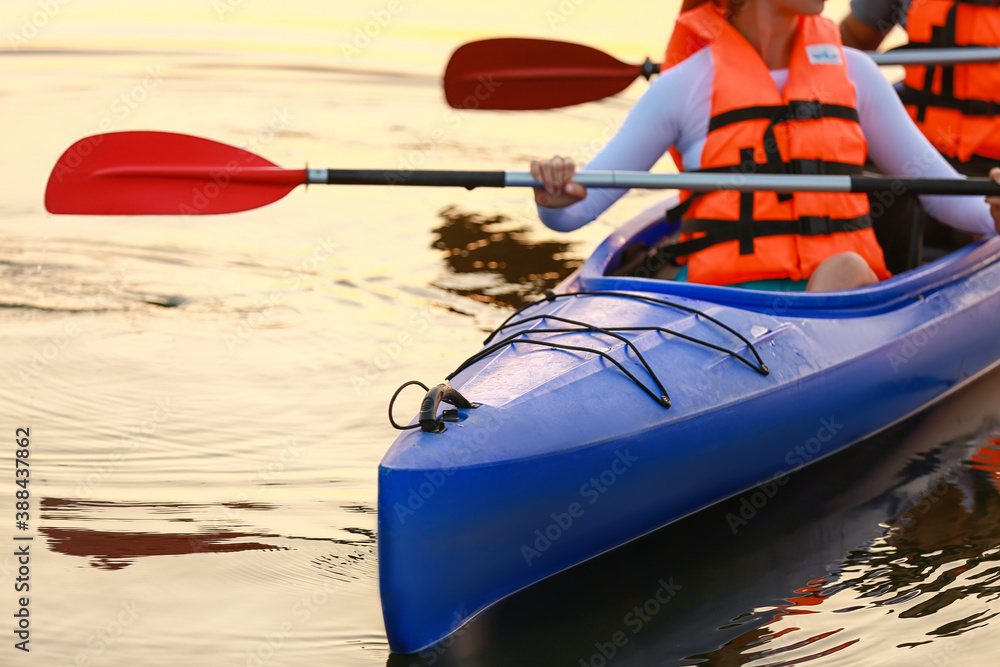 Young couple kayaking in river