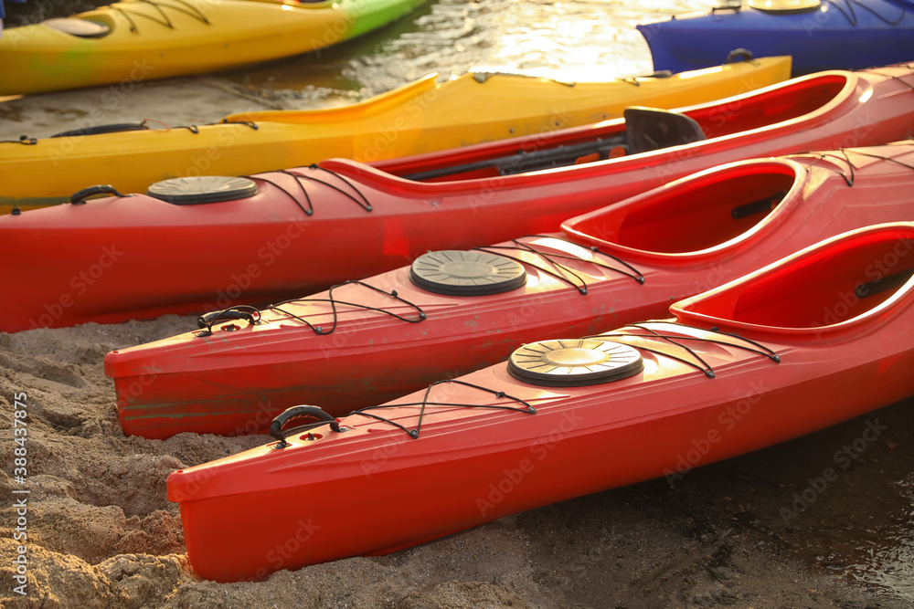 Boats for kayaking on river bank